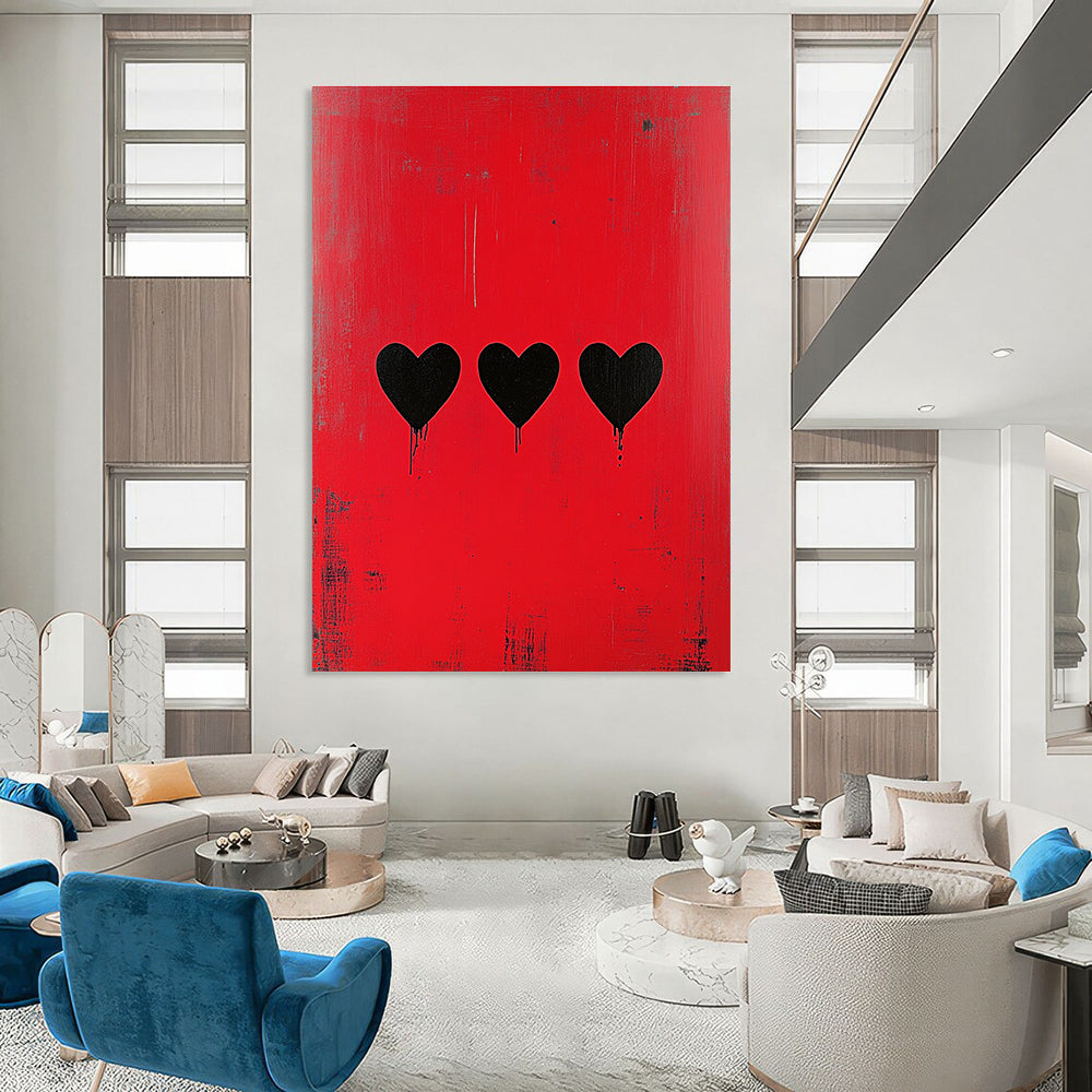 Large abstract painting with a striking red background featuring three bold black hearts in a style reminiscent of Banksy.STSC1164