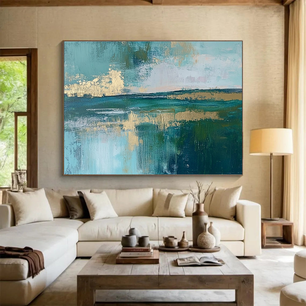 Large abstract painting featuring a serene lake, vibrant green fields, light blue sky, and elegant gold foil accents.SC115