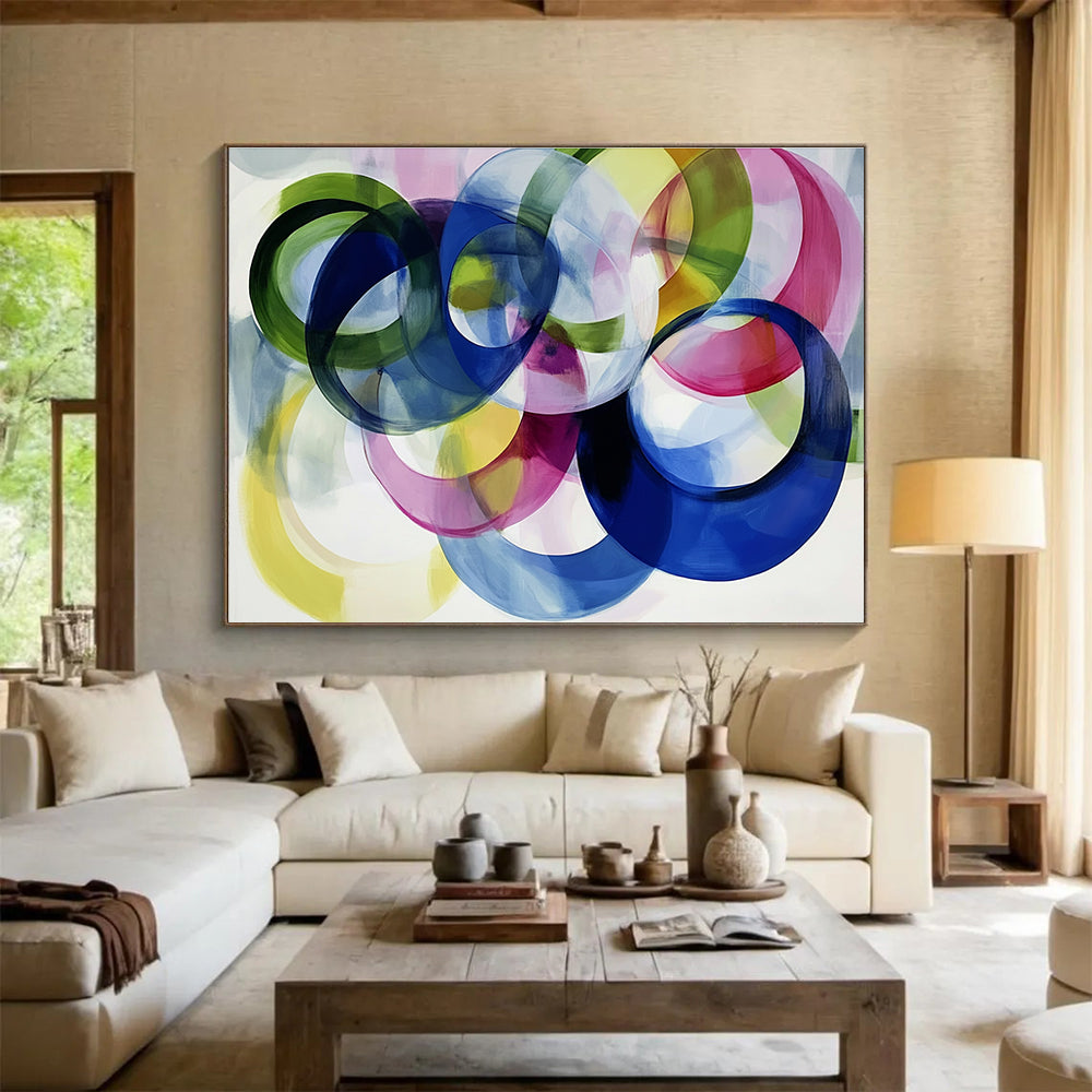 Large abstract painting with colorful overlapping circles on a white background showcasing joyful energy and playful modernity through soft edges and visible brushstrokes.SC525