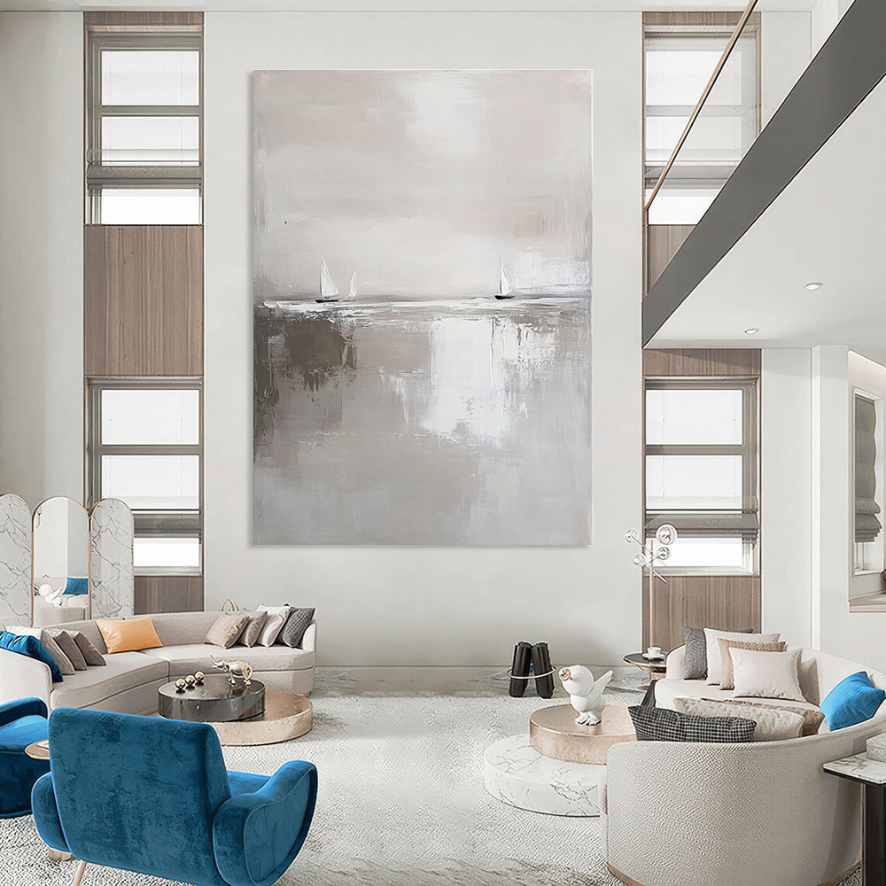 Large abstract painting in white and gray featuring calm waters and distant sailboats in a minimalist style with neutral tones.STSC359