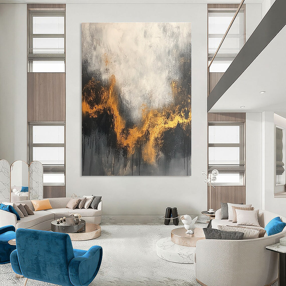 Large abstract painting with a gray and white background accentuated by gold tones and dark colors for an atmospheric effect.STSC394