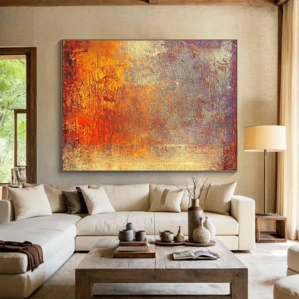 A large abstract painting featuring warm tones of gold reds and oranges evokes autumn's energy and symbolizes life's transitions with a golden sunset backdrop.SC432