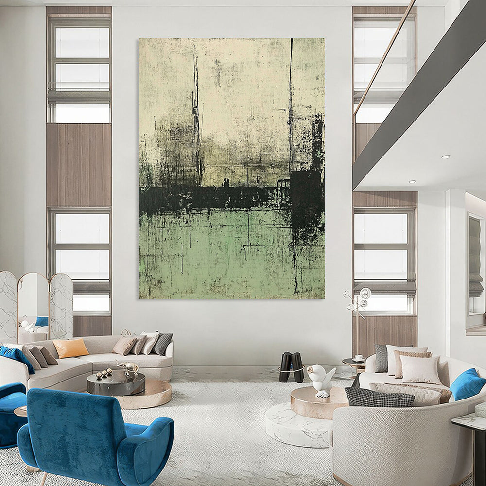 Large abstract painting featuring muted green and gray tones depicting a desolate landscape with distant buildings and water.STSC421