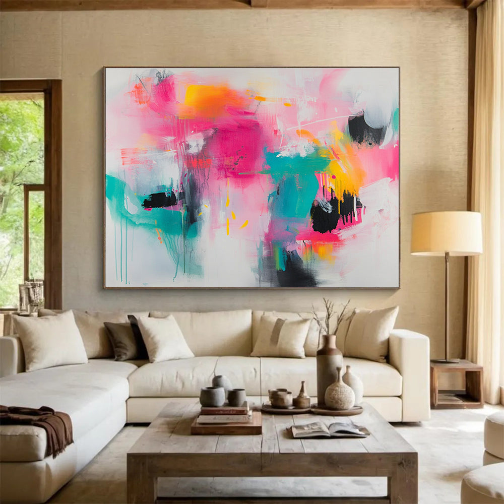 Large abstract painting featuring vibrant splashes of pink teal and yellow on a white background with loose brushstrokes and chaotic shapes.SC387