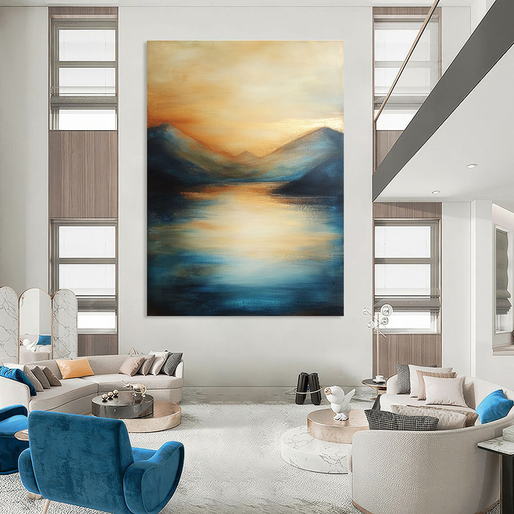 Large abstract painting of the sea featuring soft brush strokes with blue tones and golden accents creating a serene sunset atmosphere.STSC092