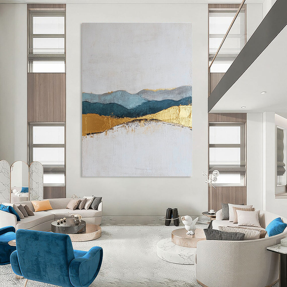 Large abstract painting featuring textured layers in neutral colors with elegant gold and blue accents for a sophisticated decor.STSC110