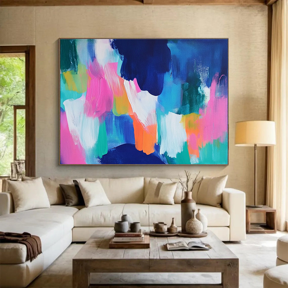 A large abstract painting with bold blue and pink backgrounds and bright orange, green, and turquoise foregrounds, conveying energy and movement.SC562