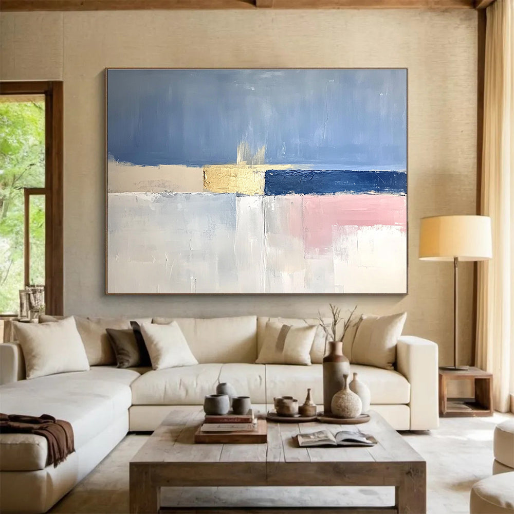 Large abstract painting featuring soft blue skies, pale pink horizons, gold highlights, and a tranquil sea in muted tones.SC025