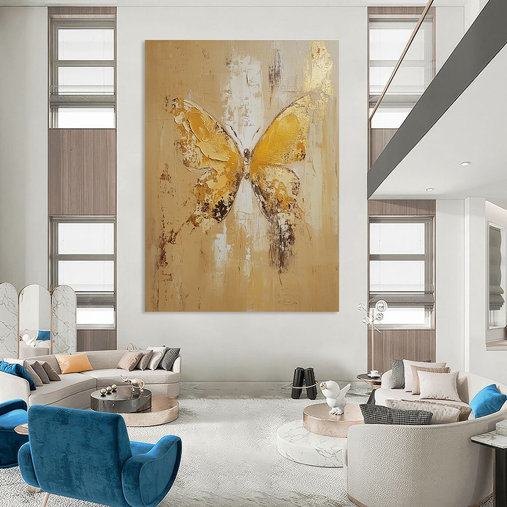 Large abstract painting of a butterfly in light yellow and beige tones with gold leaf and textured oil on canvas.STSC252