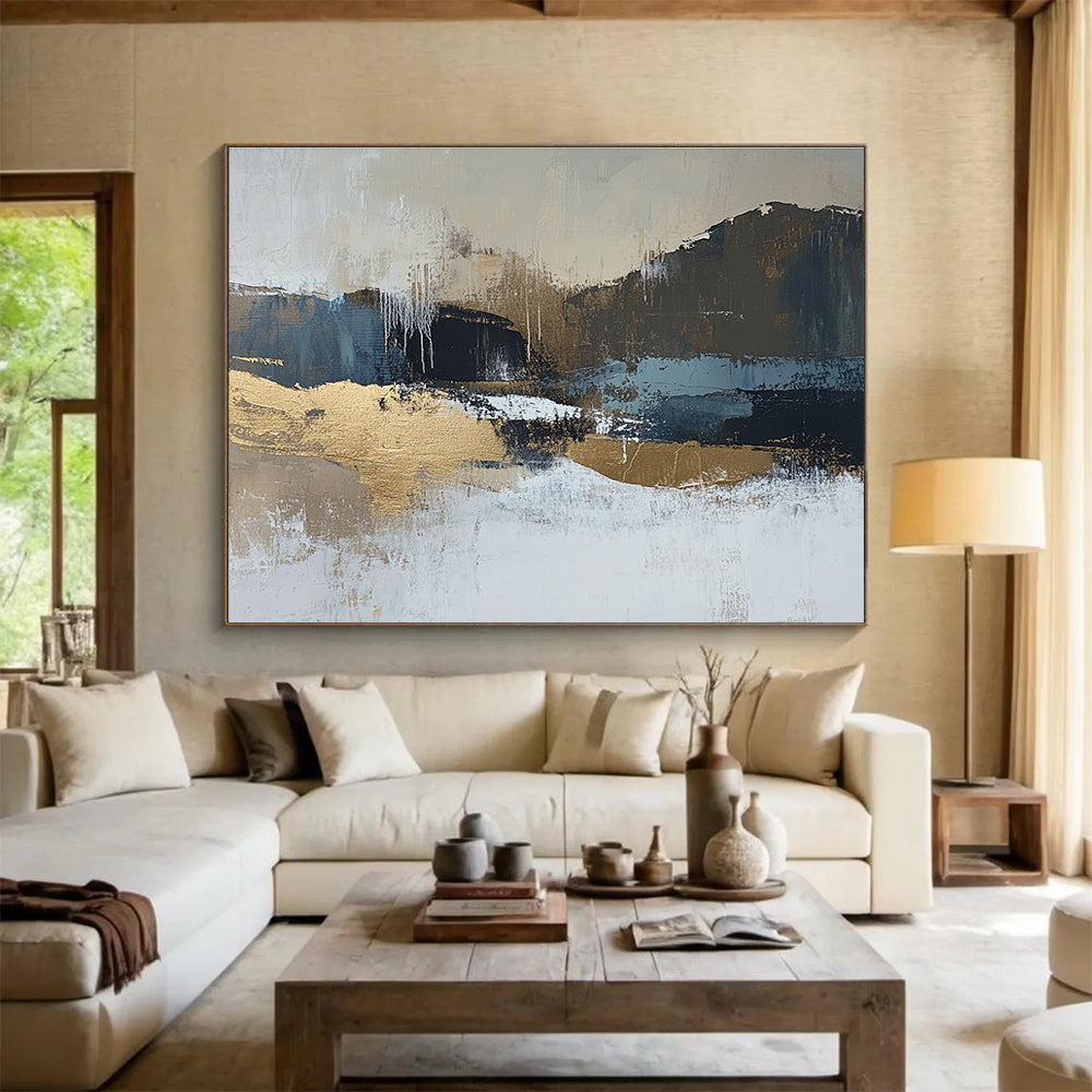 Large abstract painting in beige and dark blue tones with gold accents showcasing a minimalist winter landscape in a neutral color palette.SC226