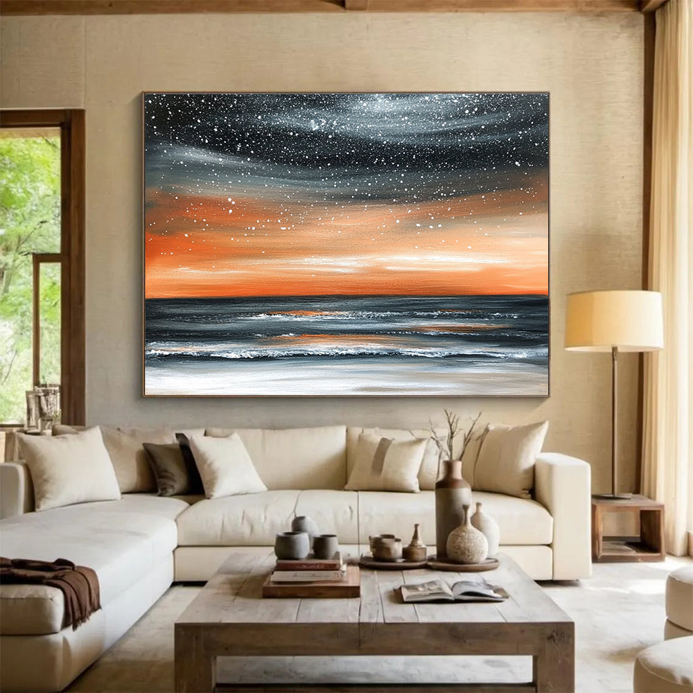Large abstract painting of the ocean at night featuring an orange gray sky and starry snowfall over a muted water surface.SC130