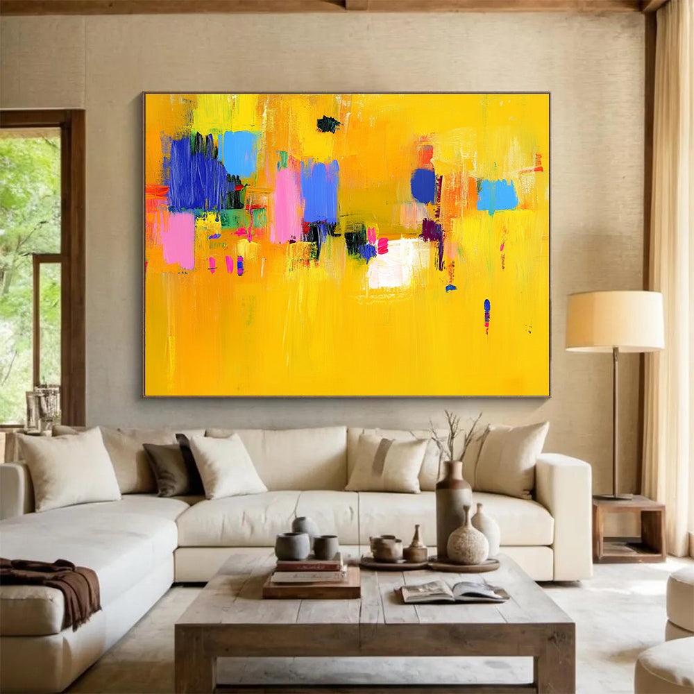 Large abstract painting featuring bold yellow and blue strokes with pink accents dynamic lines and vibrant textures creating an energetic atmosphere.SC147