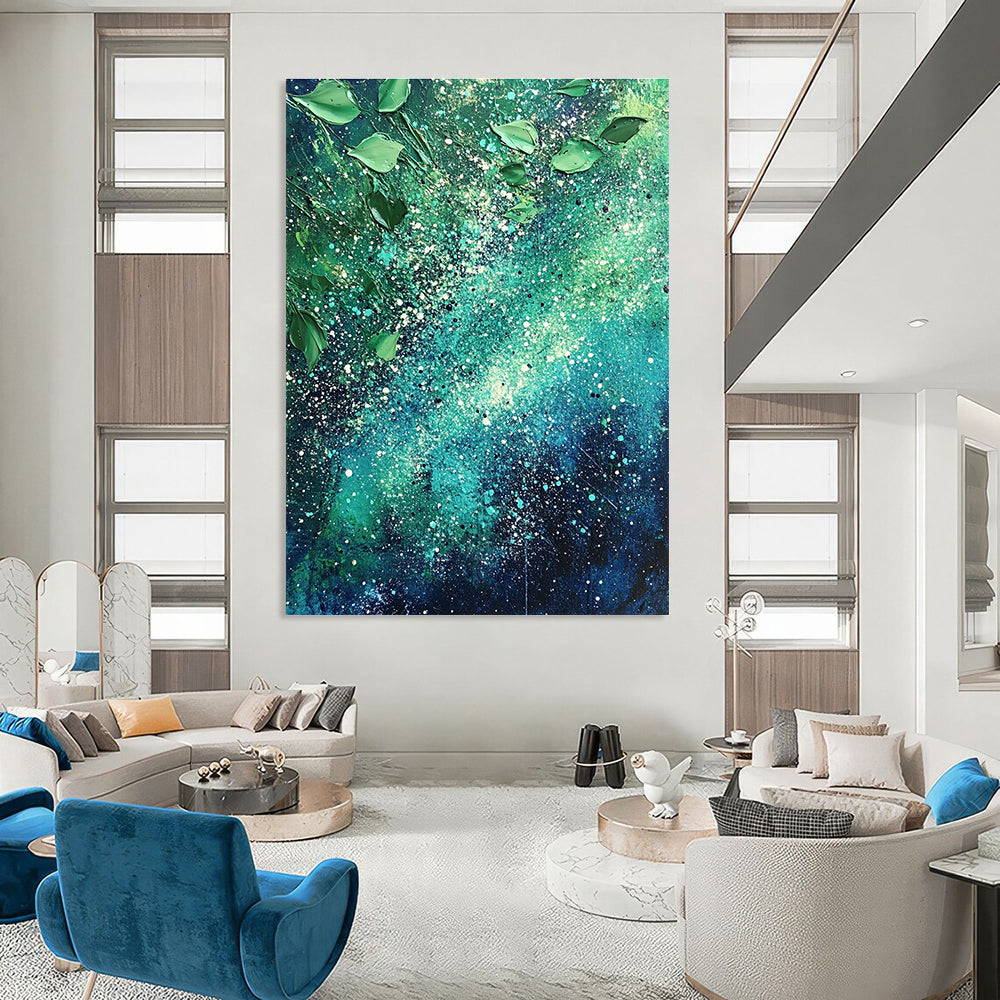 Large abstract painting of the Milky Way featuring vibrant green and blue hues with white speckles and scattered leaves for texture and cosmic beauty.STSC065