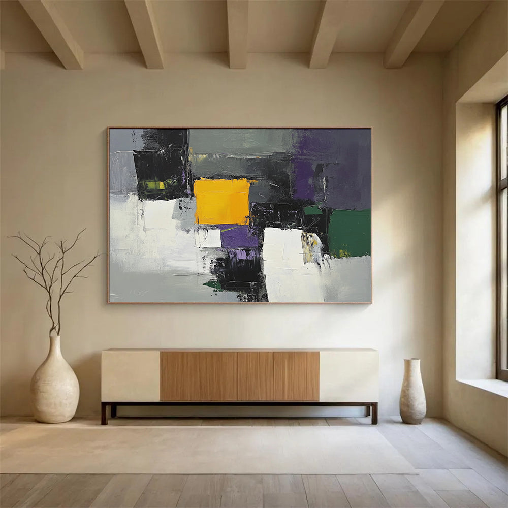 This large abstract painting features gray white and purple shapes with a central yellow square and green and olive accents using thick brush strokes.SC324