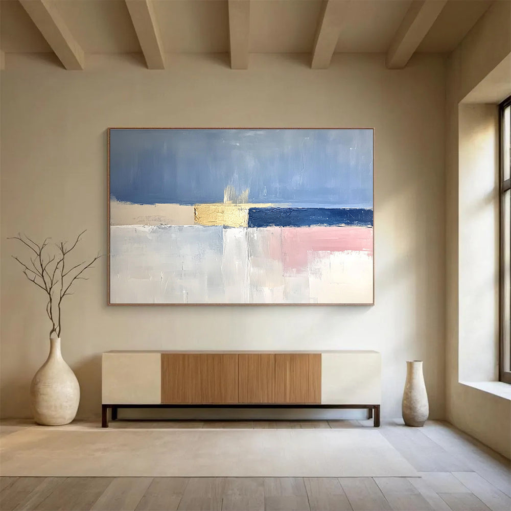 Large abstract painting featuring soft blue skies, pale pink horizons, gold highlights, and a tranquil sea in muted tones.SC025