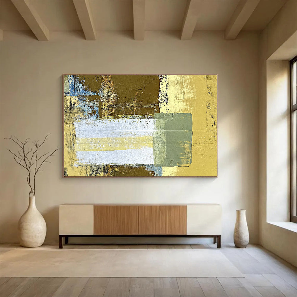Large abstract painting featuring beige and yellow tones with a central white rectangle and green stripe against a dark brown background.SC425