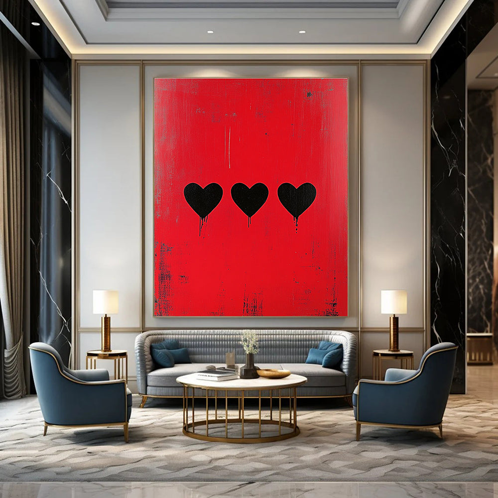 Large abstract painting with a striking red background featuring three bold black hearts in a style reminiscent of Banksy.STSC1164
