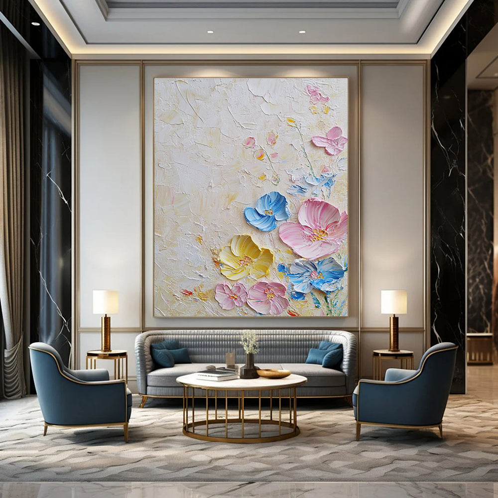 Large abstract painting with textured layers featuring pastel flowers in pink and blue on a white background illuminated by soft lighting.STSC1366