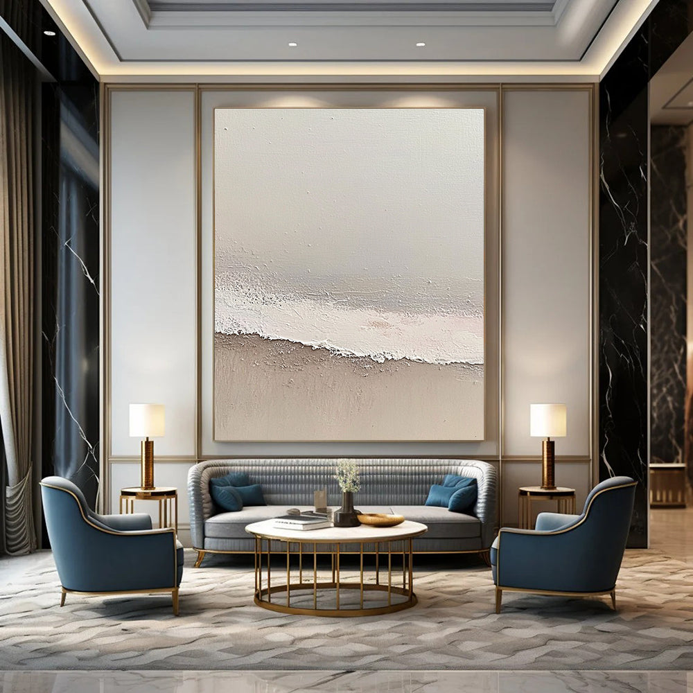 Large abstract painting depicting a serene beach scene with soft gray and pale pink tones featuring gentle waves and textured surfaces.STSC1427