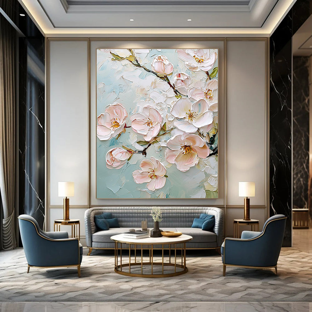 Large abstract painting featuring delicate cherry blossoms in soft pink and white against a light blue background with rich impasto texture.STSC875