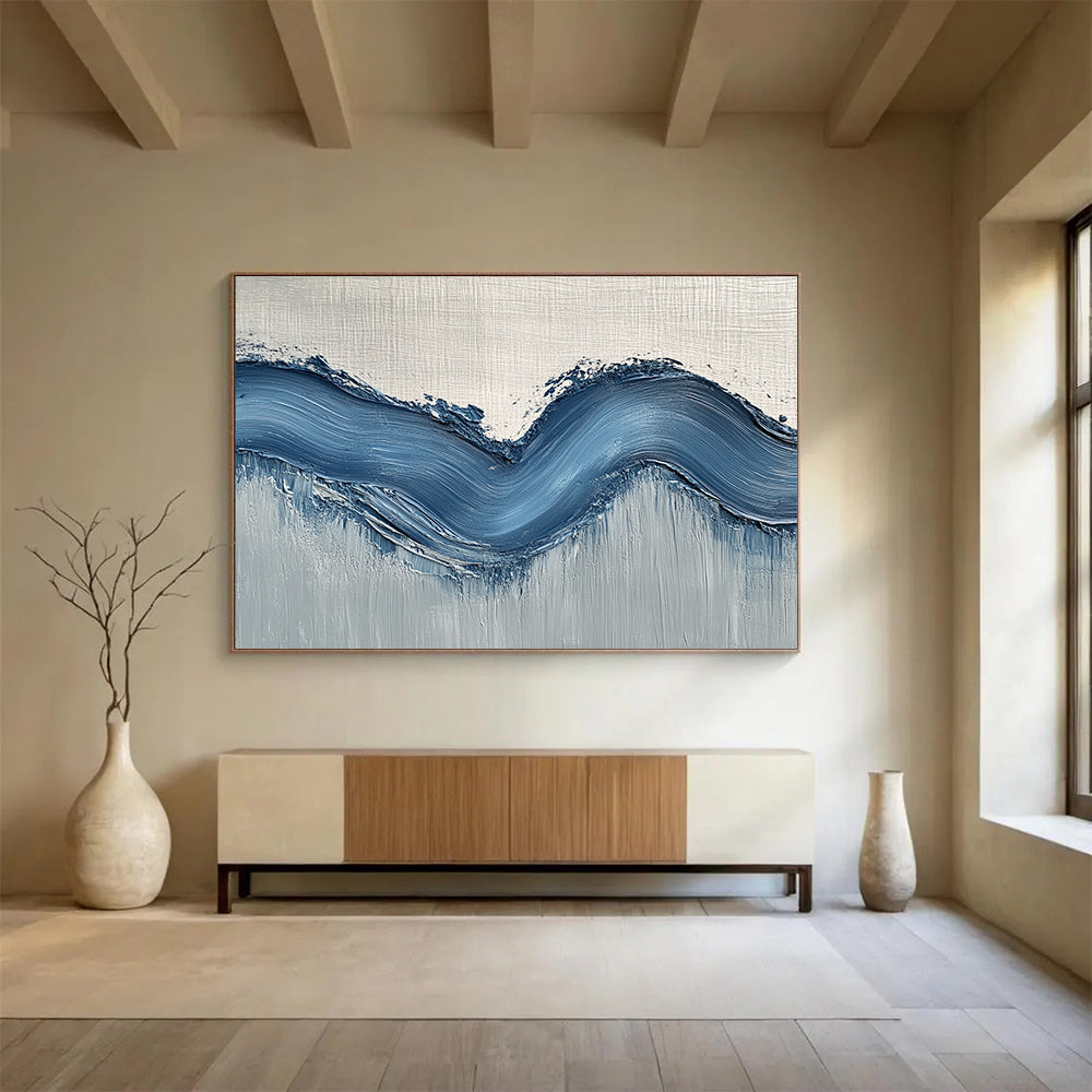 Large abstract painting with gentle blue hills on light gray wall, showcasing depth and movement for a modern aesthetic.SC453