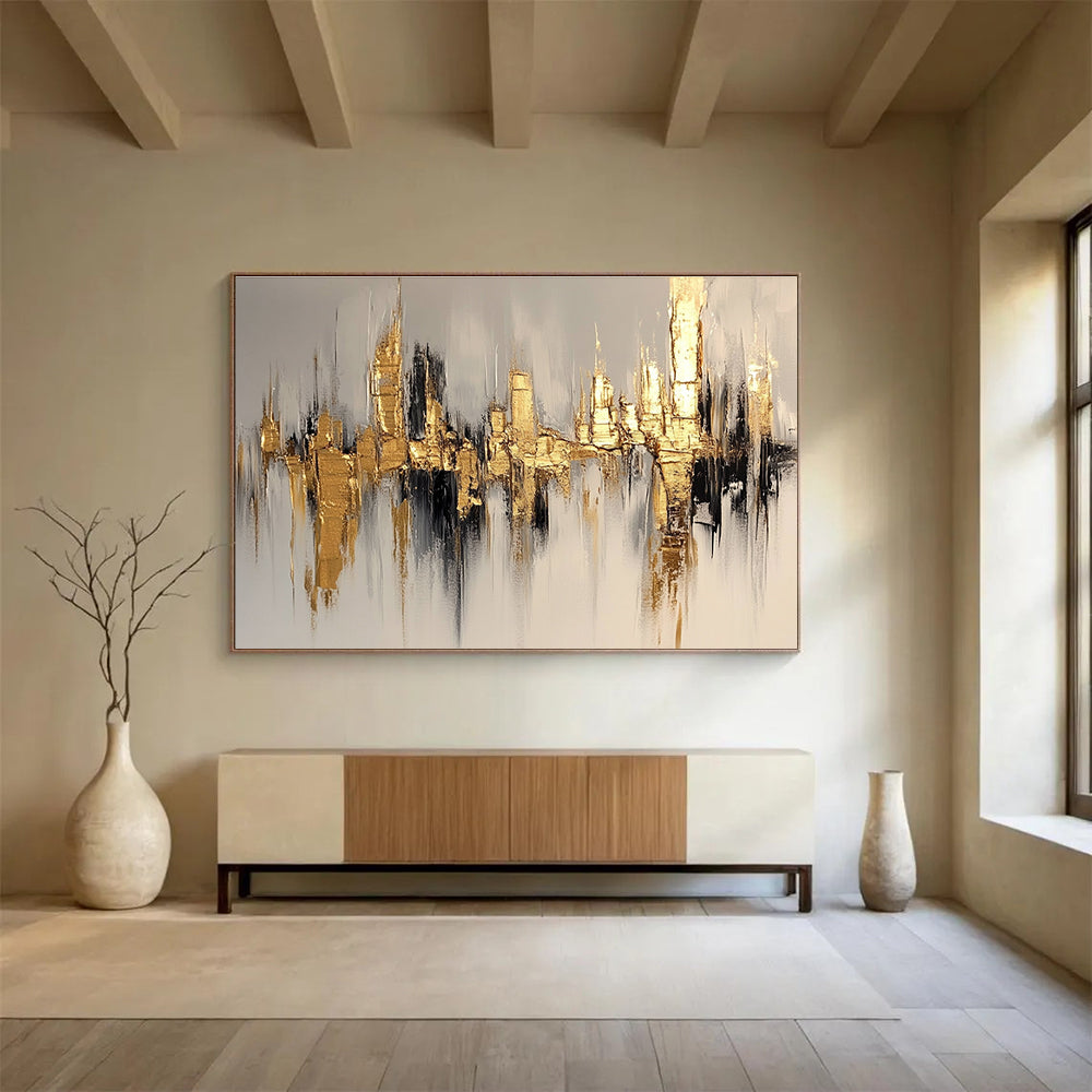 Large abstract painting of a cityscape in gold and white, featuring bold brush strokes on a white background with neutral tones.SC170
