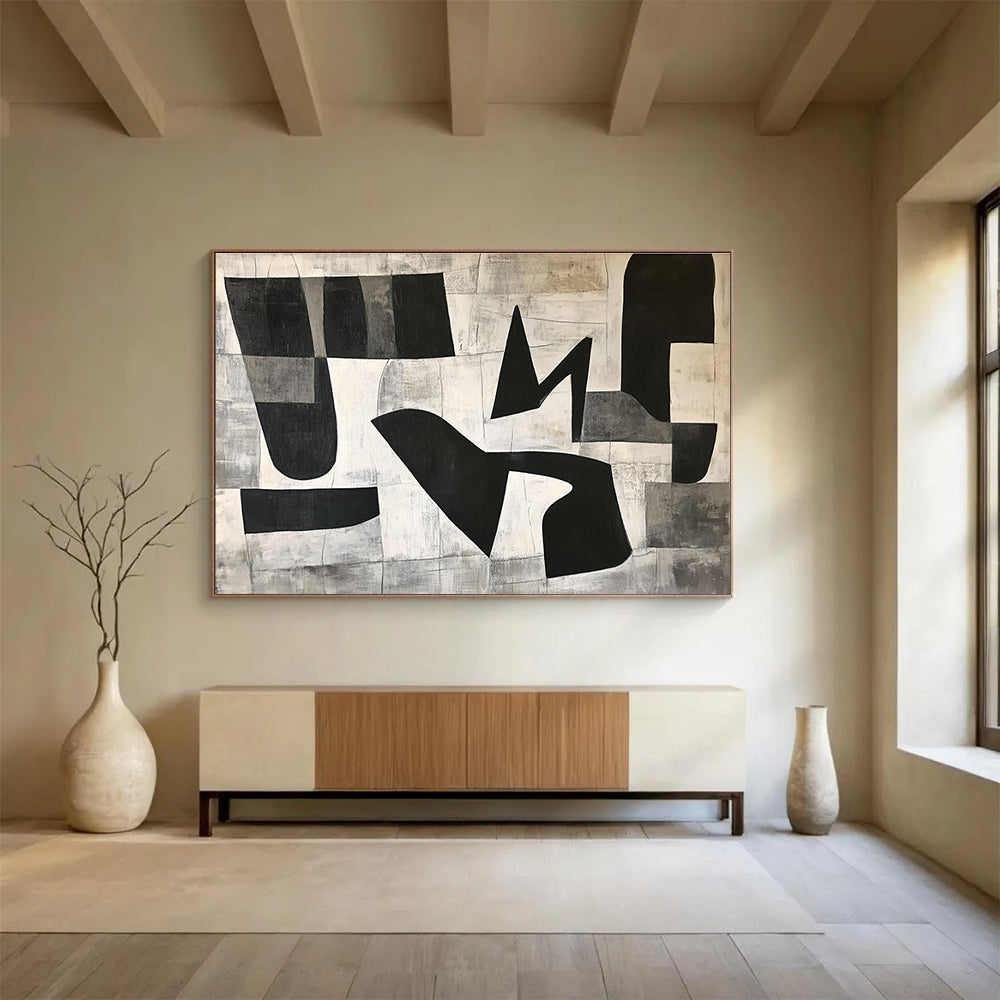 Large abstract painting featuring black and white geometric shapes in the letter K on a textured minimalist background conveying depth and movementSC517