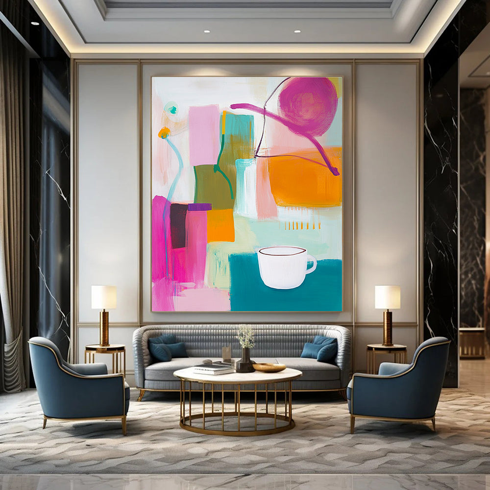 An abstract painting features vibrant pink green and yellow shapes with an orange object and a white cup on top alongside blue and purple lines.STSC787