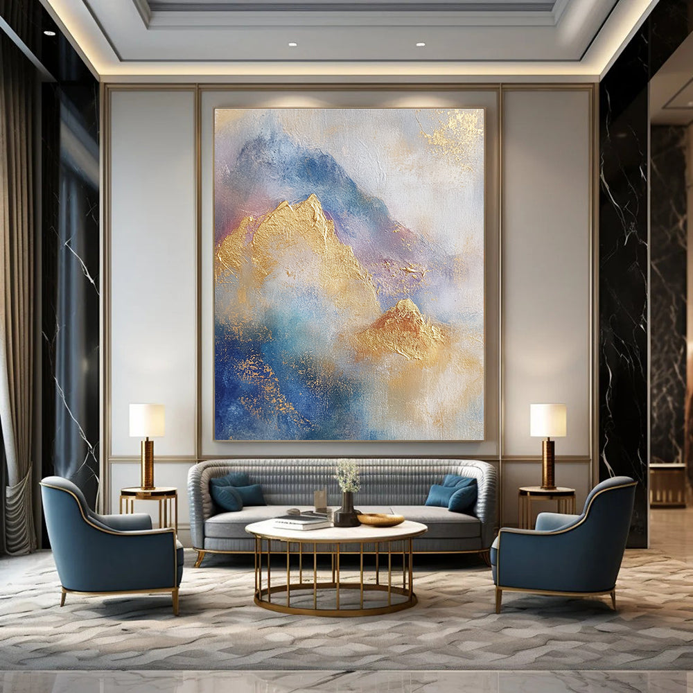 Large abstract painting featuring soft blue and gold tones with gilded mountains and textured brushstrokes for a striking visual impact.STSC446