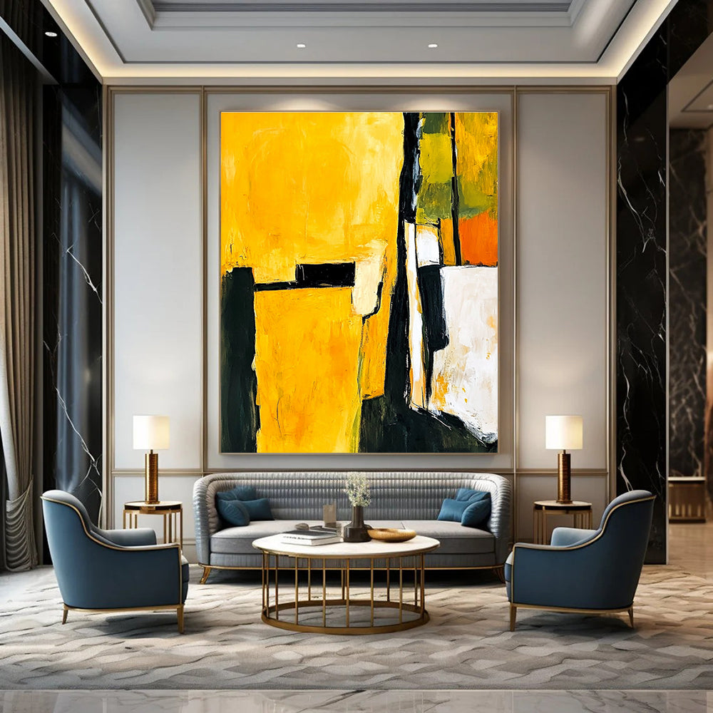 Abstract painting in yellow and black featuring white shapes with a minimalist atmosphere and an armchair in the foreground.STSC718