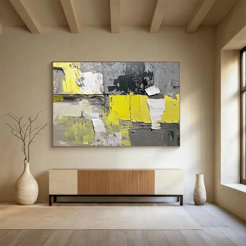 Large abstract painting featuring gray and yellow hues with textured paper elements extending from the wall for added dimension.SC240