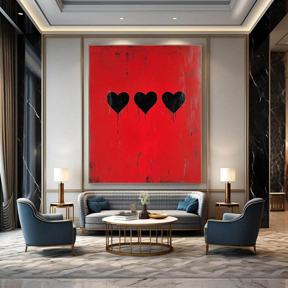 A large abstract painting featuring three black hearts on a red background inspired by Banksy’s minimalistic style.STSC1442