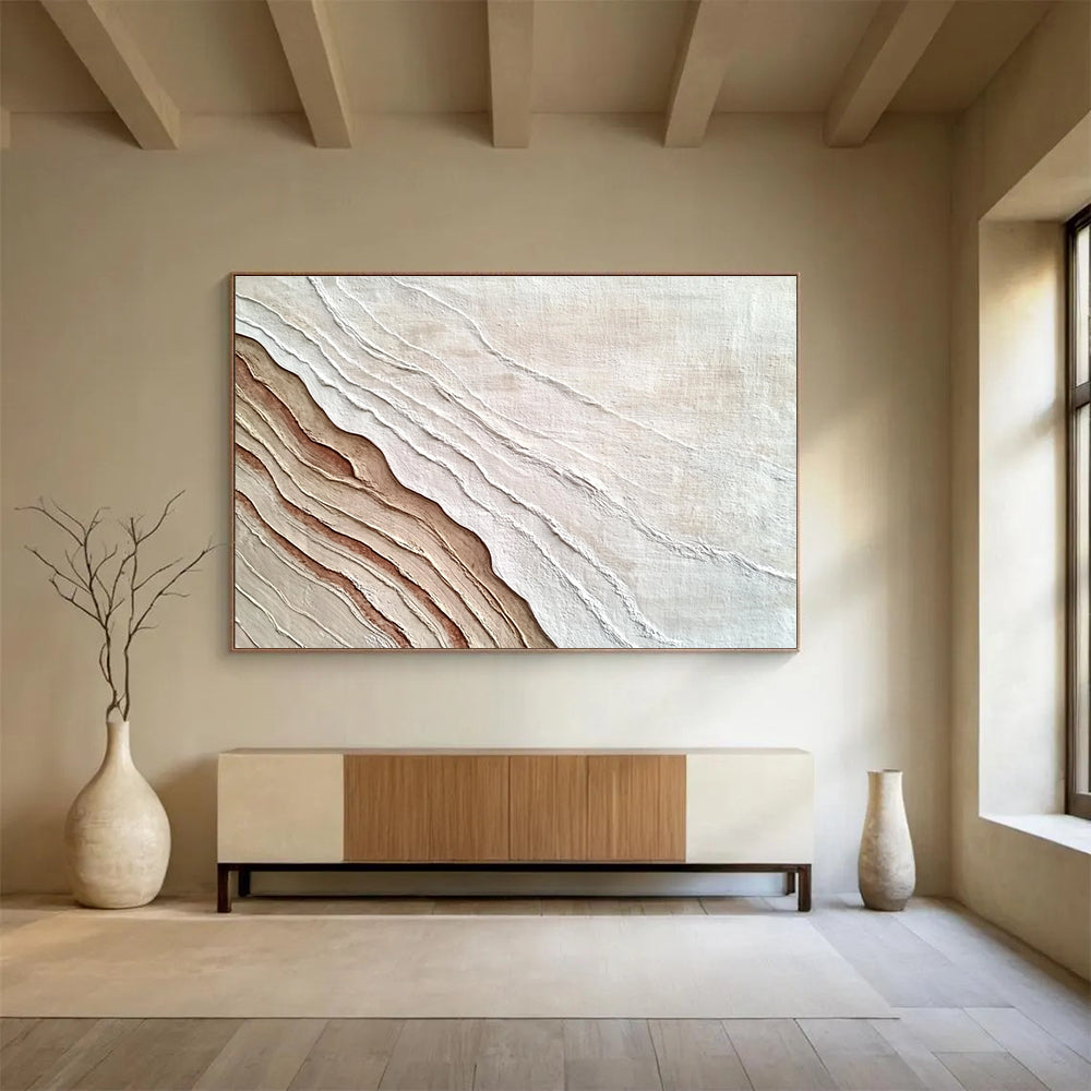 An abstract painting featuring the interplay of sand and water in white and brown hues, symbolizing growth and change through rich textures.SC448
