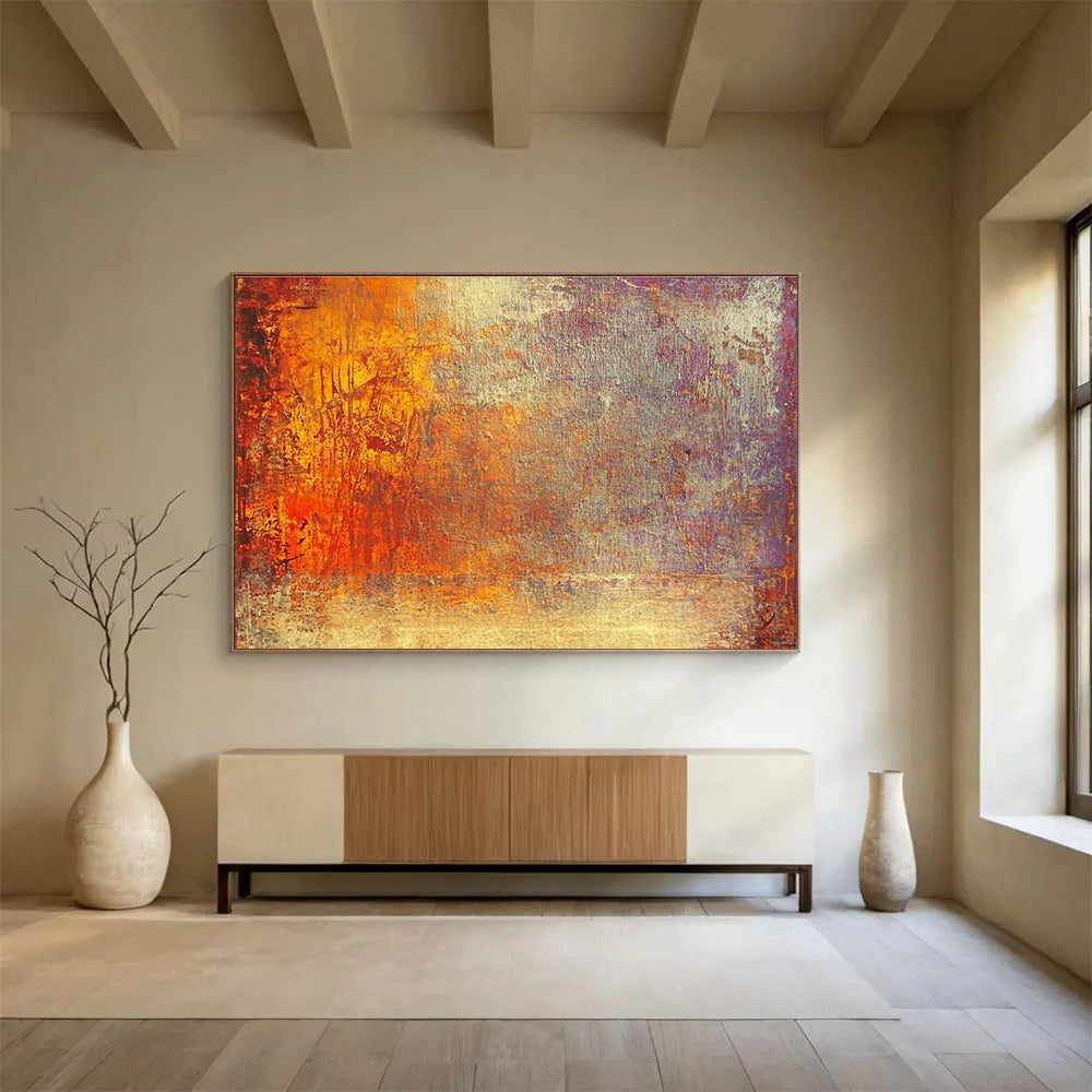 A large abstract painting featuring warm tones of gold reds and oranges evokes autumn's energy and symbolizes life's transitions with a golden sunset backdrop.SC432
