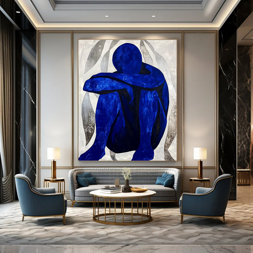 Large abstract painting featuring a contemplative blue figure amidst silver swirls, evoking tranquility and focus in a minimalist style.STSC922