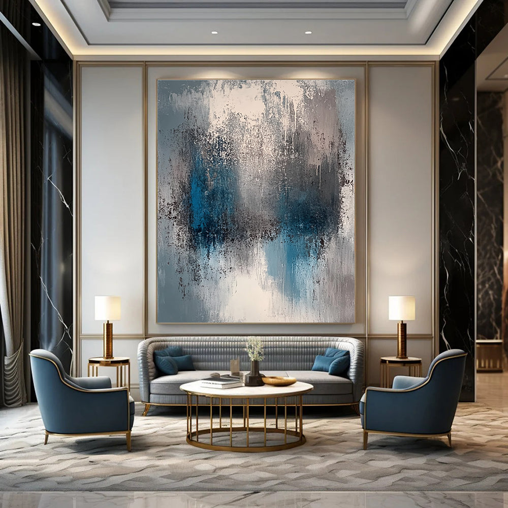 A large abstract painting featuring a faded gray and blue color palette with soft lighting and neutral tones.STSC577