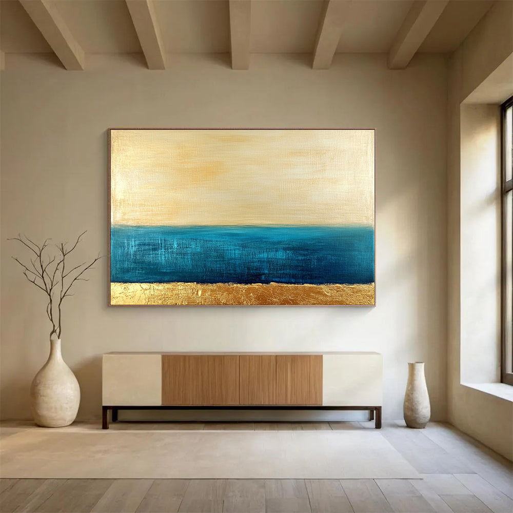 Large abstract painting featuring a golden sky and blue sea with textured gold accents and a soft minimalist aesthetic.SC172