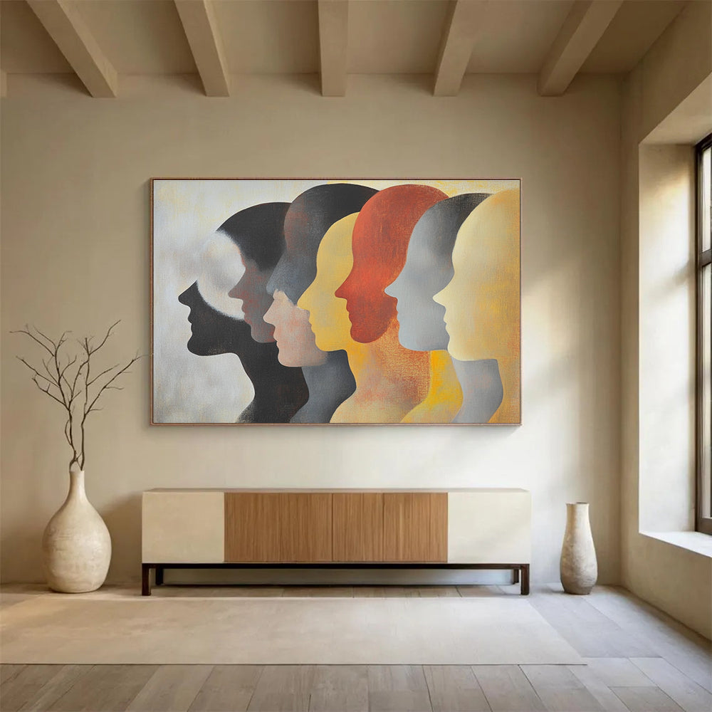 Large abstract painting featuring faces in profile with diverse skin tones and hairstyles in soft colors on a light background.SC548