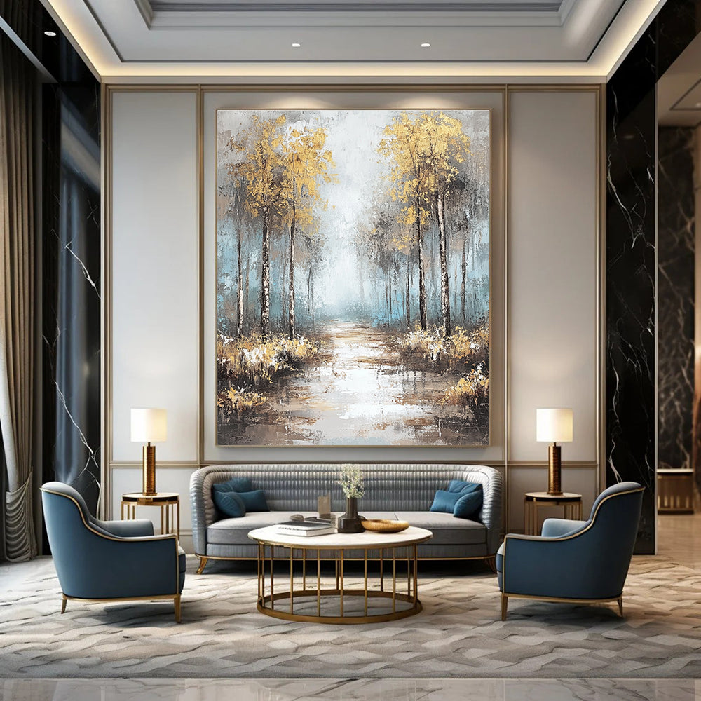 Large abstract painting featuring soft blues and grays with gold leaf accents creating a tranquil misty forest landscape.STSC060