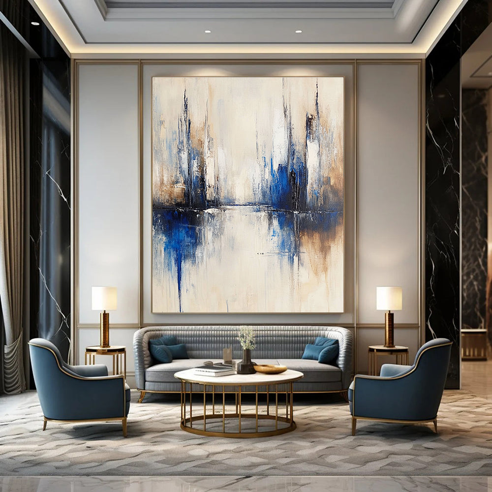 Large abstract painting of a city with muted white and blue tones on a beige background featuring blurred brush strokes reflecting in water.STSC134