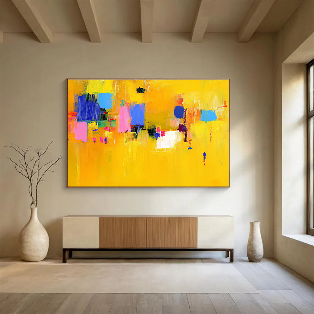 Large abstract painting featuring bold yellow and blue strokes with pink accents dynamic lines and vibrant textures creating an energetic atmosphere.SC147
