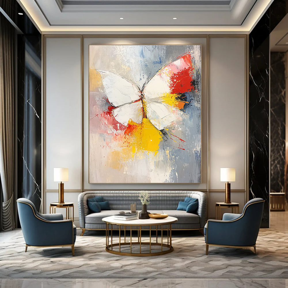Large abstract painting featuring a white and red butterfly with vibrant yellow feathers set against a soft gray and pink background.STSC552
