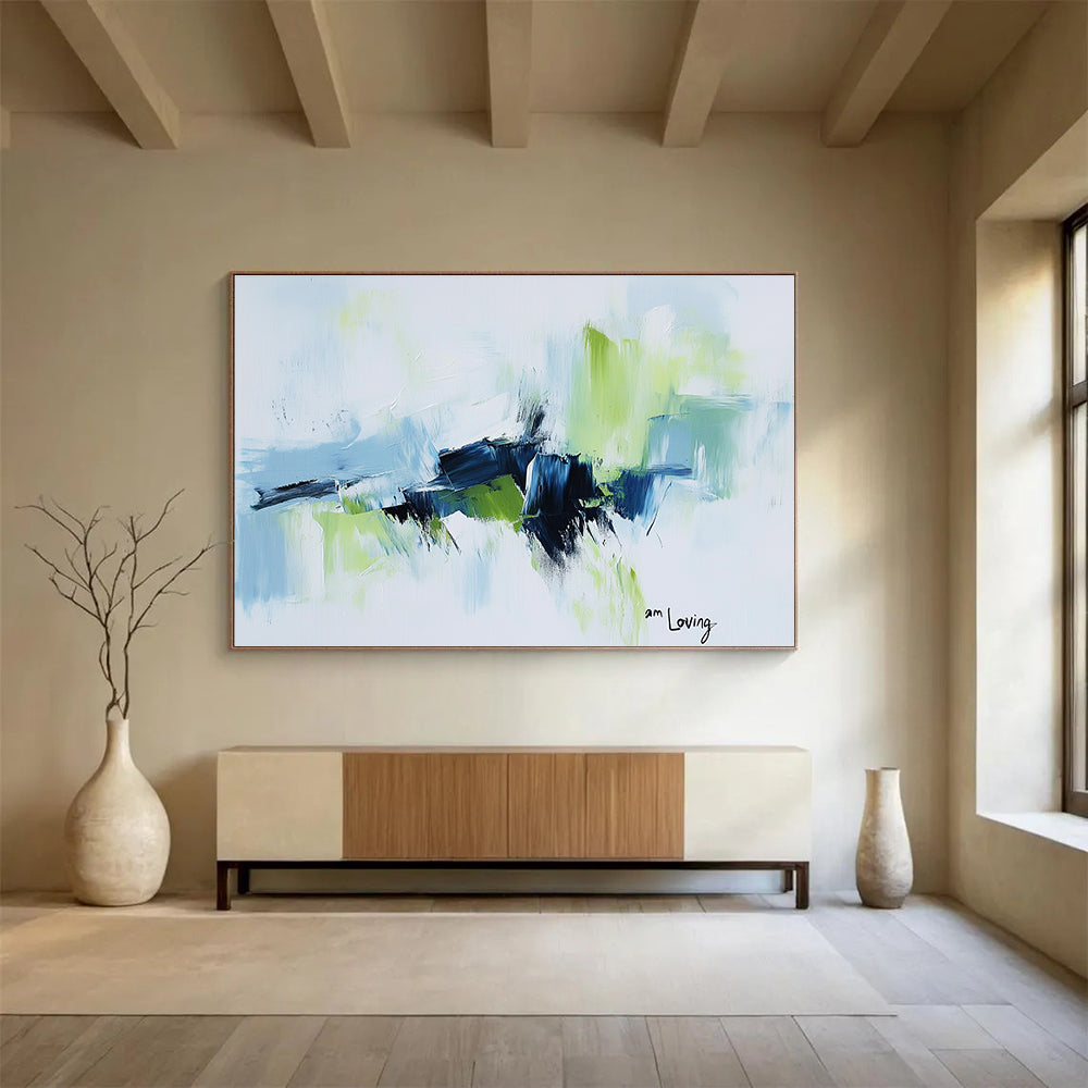 Abstract painting with a white background highlighted by light blue and green accents features expressive brush strokes and the words am loving.SC214