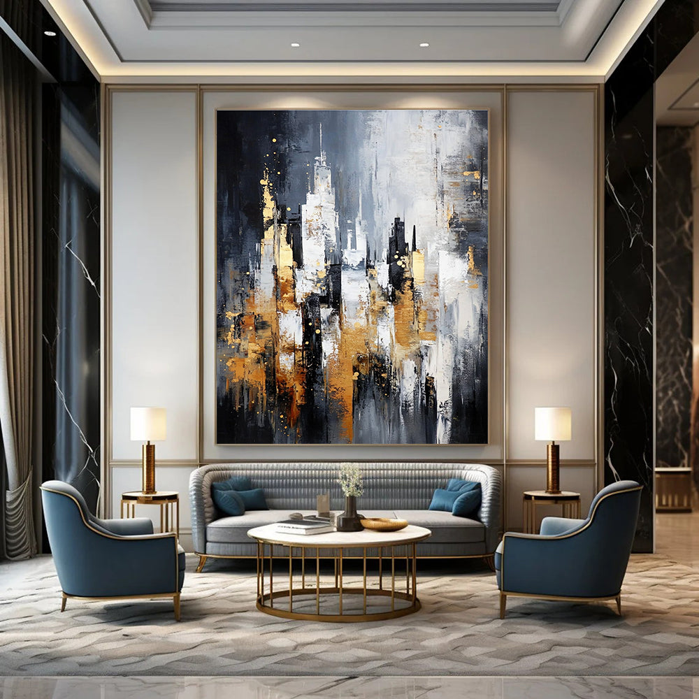 Large abstract painting of a cityscape in gray and white with gold accents on a dark background featuring neutral tones.STSC282