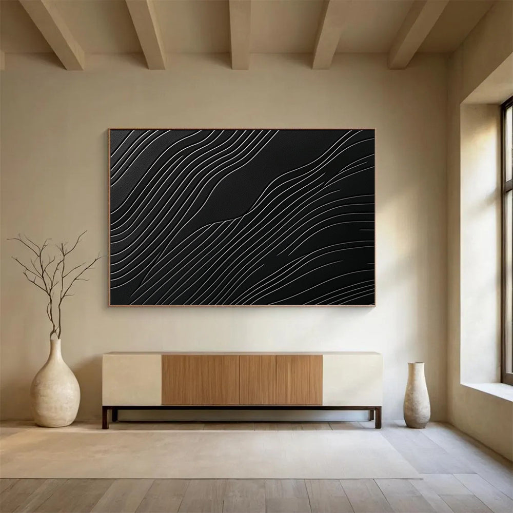A large abstract artwork featuring elegant wave patterns on a matte black surface, showcasing layered textures and high contrast between light and dark tones.SC575