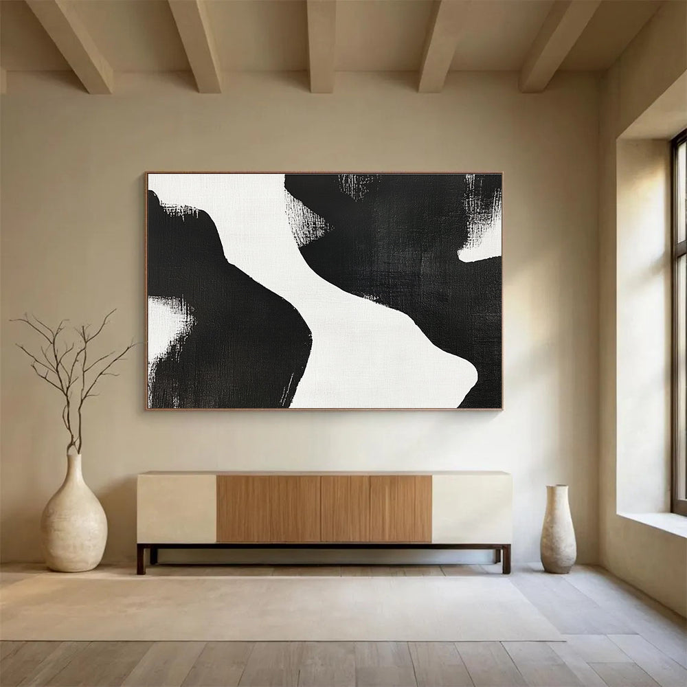 Large abstract painting featuring black and white brush strokes depicting two women’s bodies against a plain white background, showcasing minimalist artistry and tranquil form.SC439
