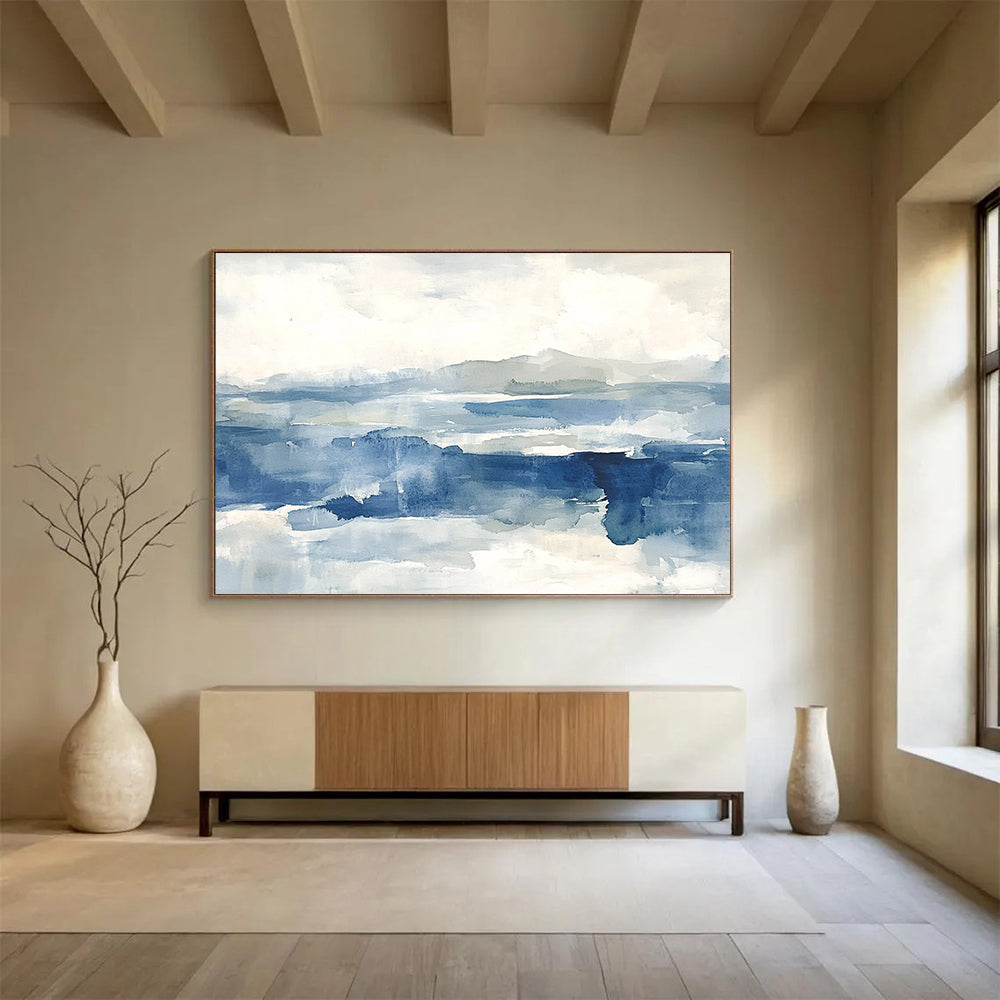 Large abstract painting of the sea features shades of blue and gray with soft clouds, evoking a stormy atmosphere and depth.SC289