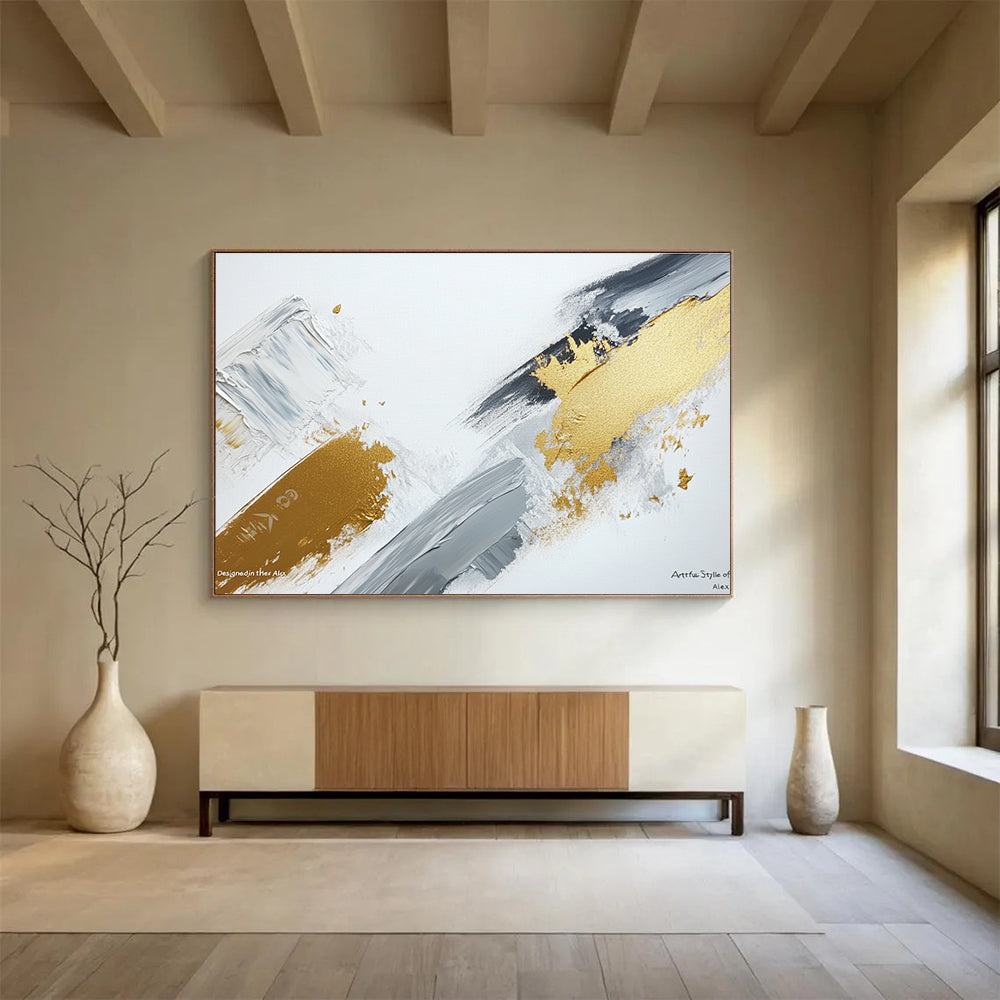 Large abstract painting featuring gray and gold brush strokes on a white background showcasing contemporary artistic creativity and elegance.SC293