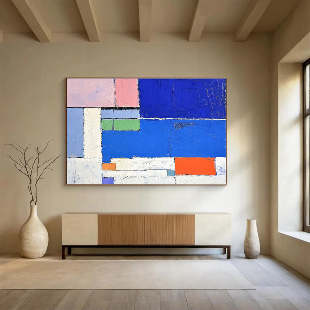 Large abstract painting featuring a vibrant blue sea white beach and colorful hotel with thick brush strokes and geometric shapes.SC169