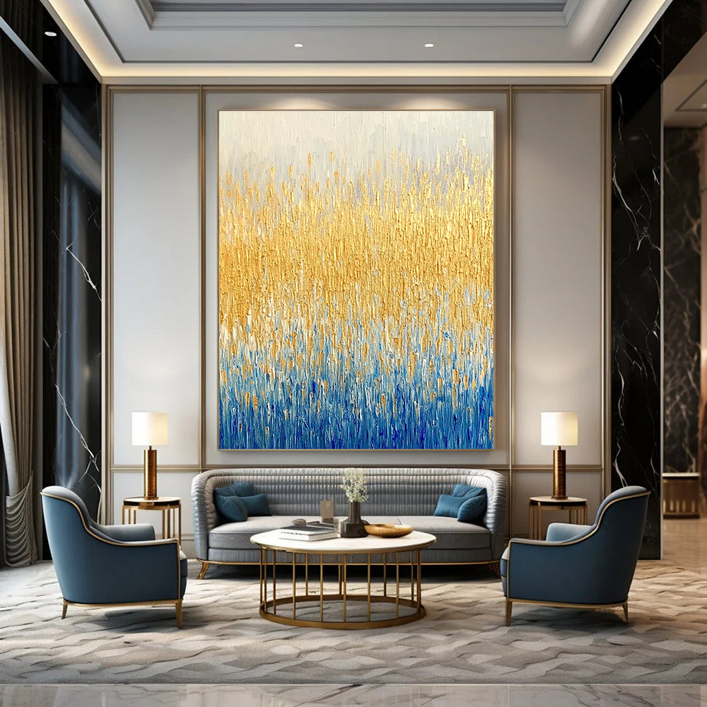 Large abstract painting of a textured wheat field in gold and blue hues showcasing fine art style and neutral tones.STSC291